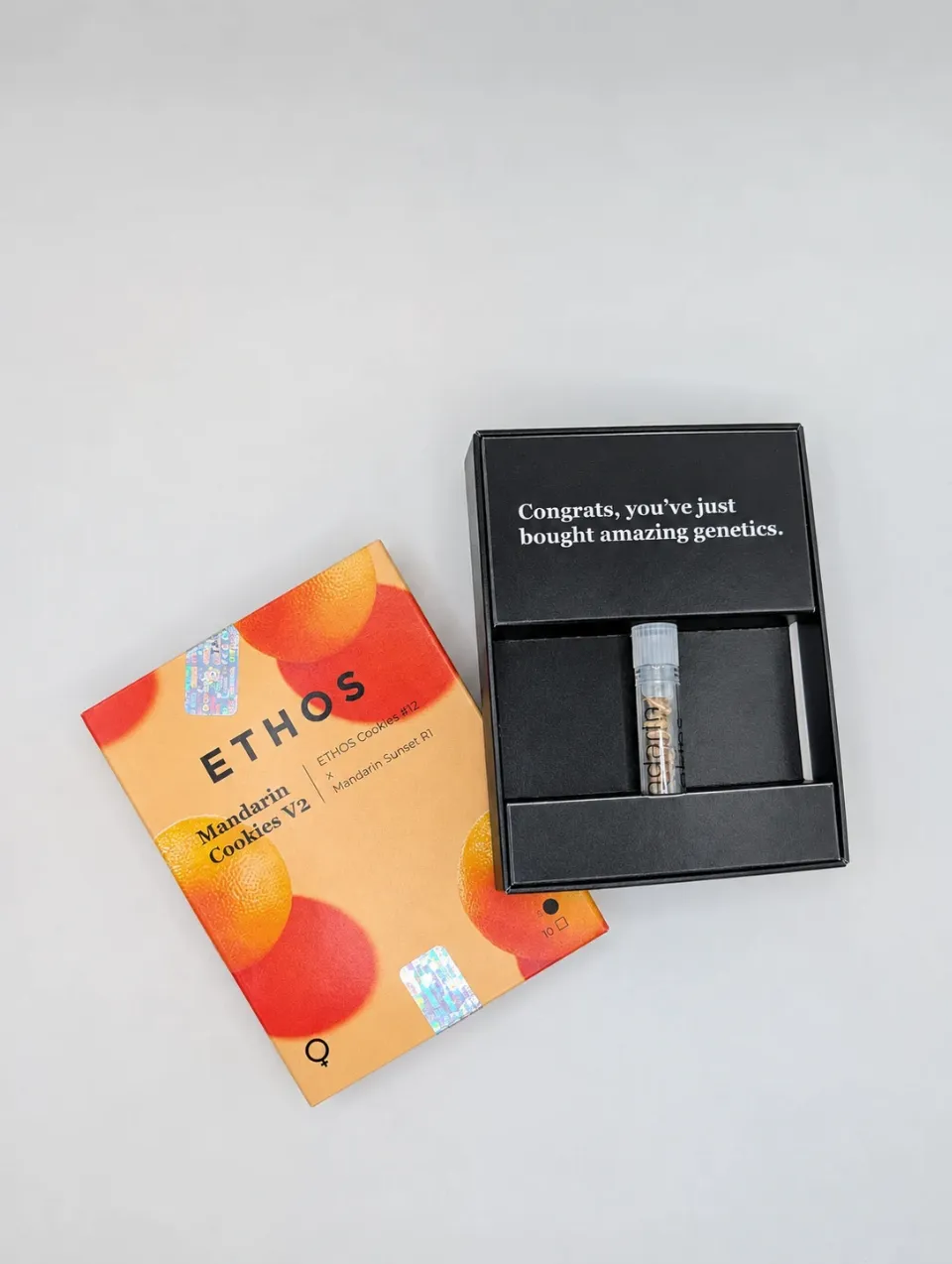 ETHOS Mandarin Cookies V2 seed packaging beside an open black box and seed vial on a light background